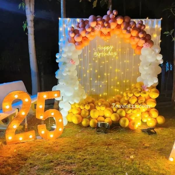 25th birthday backdrop decoration with milestone-themed banner and balloon arrangement