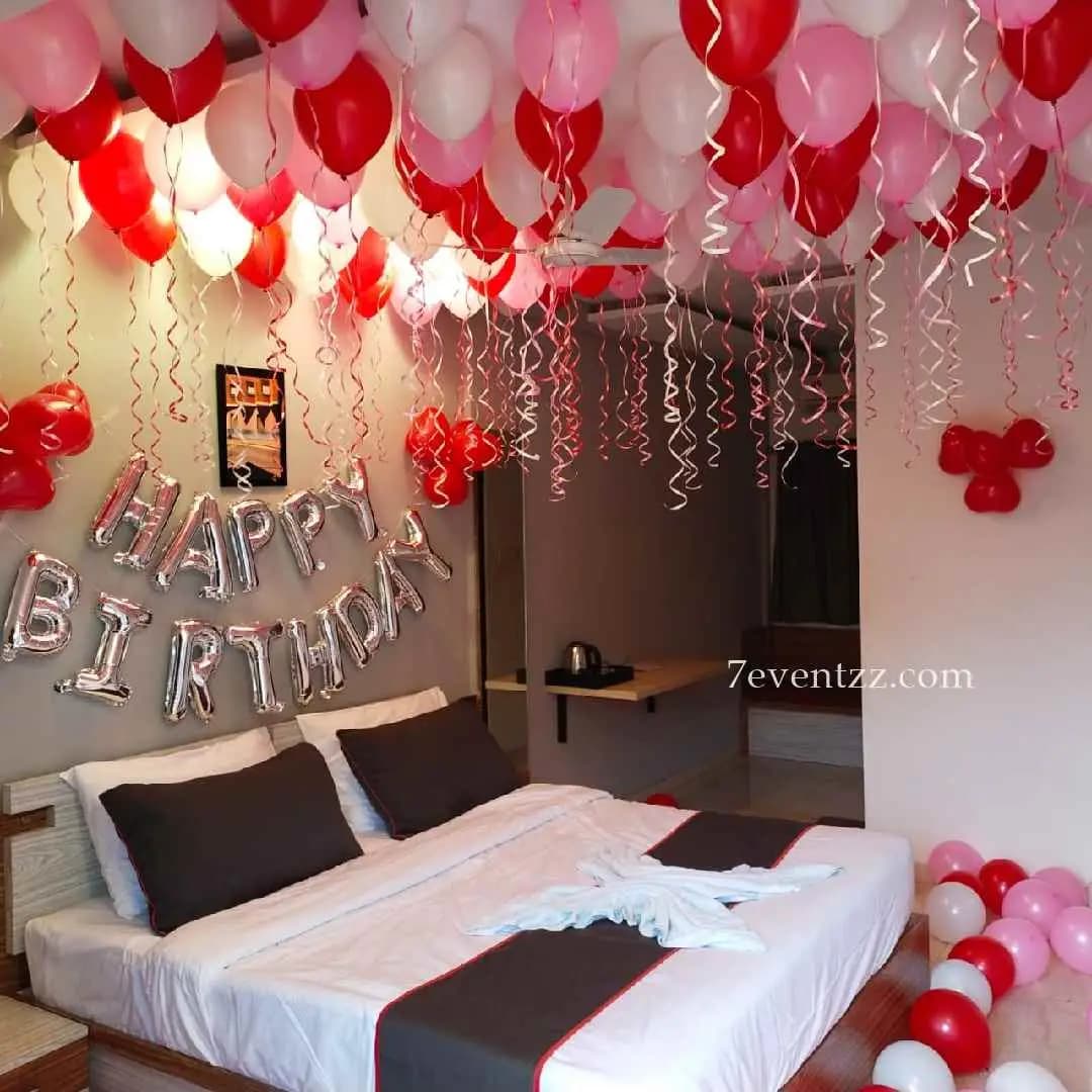 Simple room decoration for birthday with balloons, lights, and backdrop
