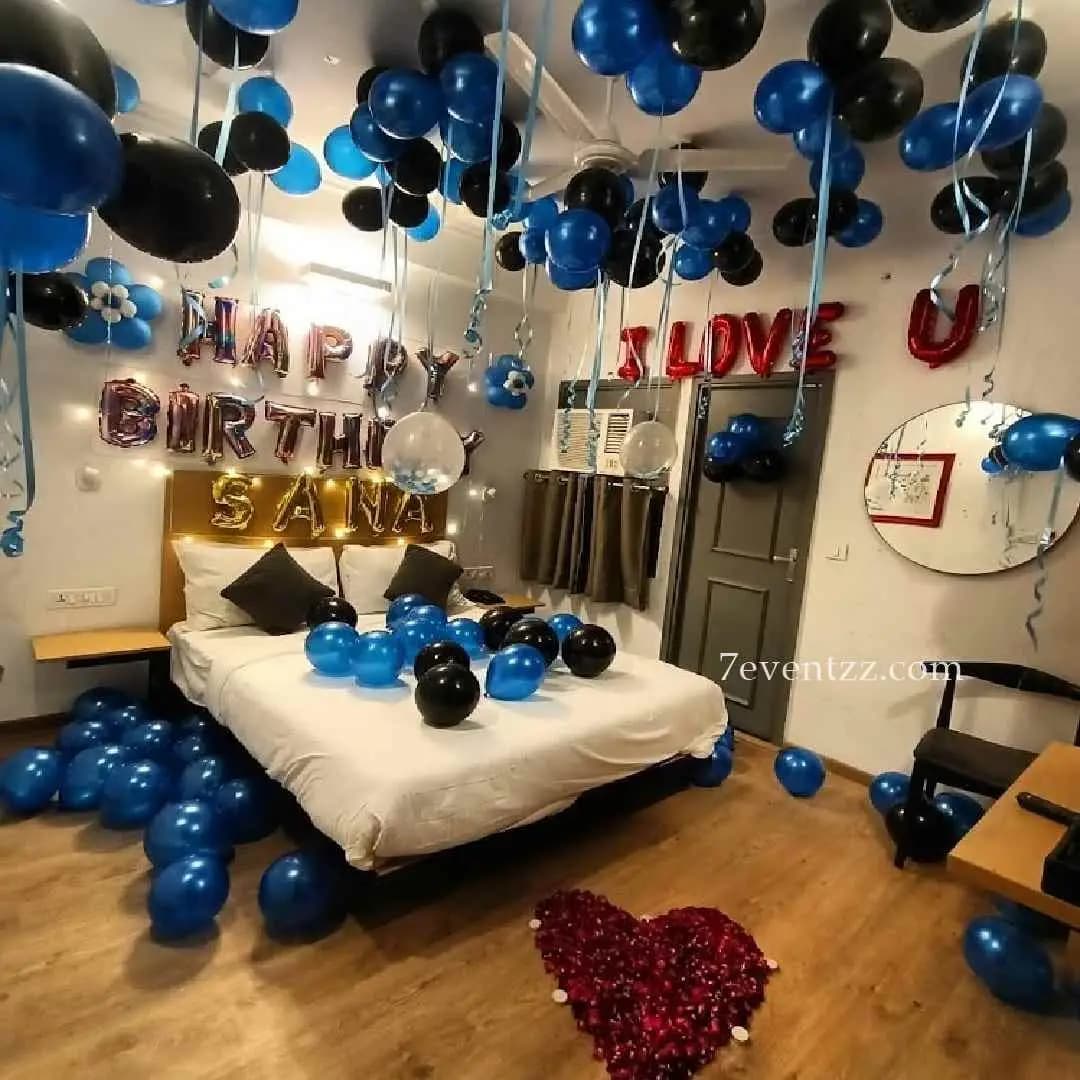 Romantic room decoration setup for couples with balloons and lighting