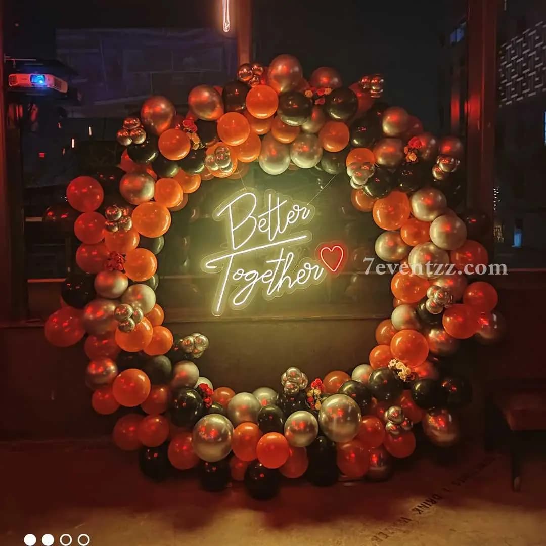 Beautiful "Better Together" anniversary room decoration with rose gold balloons and floral backdrop