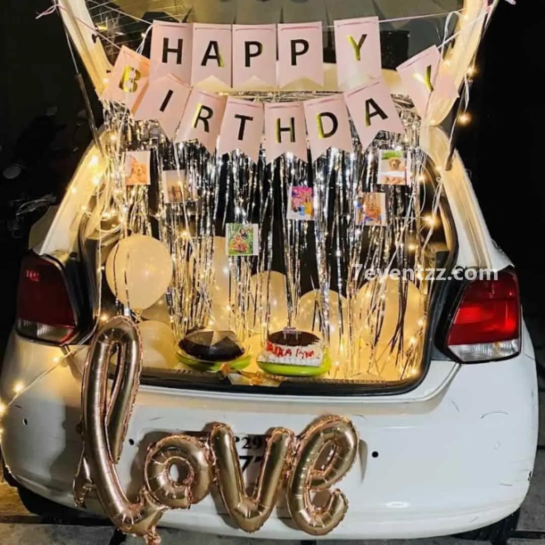Birthday-themed car boot surprise with banners and balloons