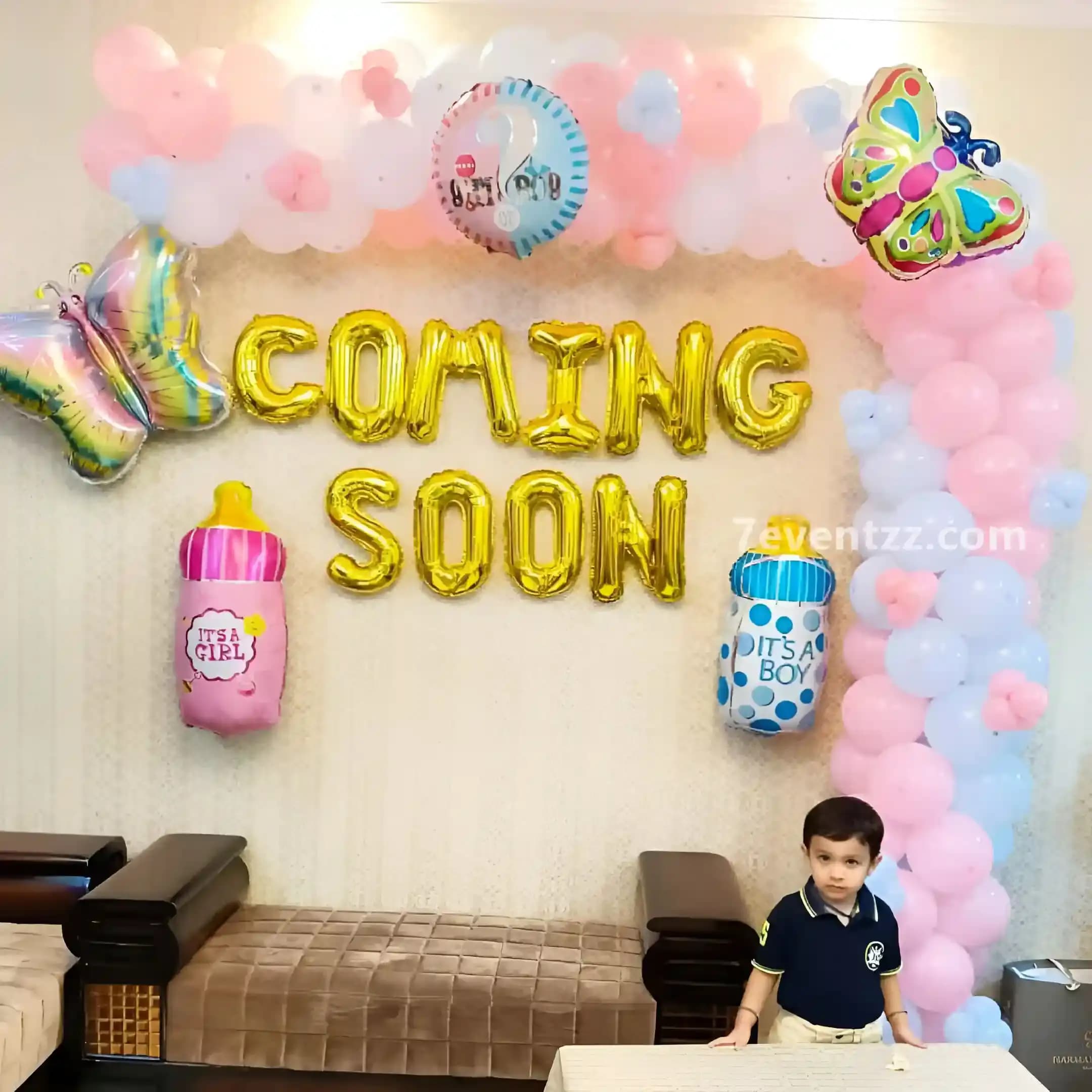 Butterfly themed Oh Baby baby shower decoration with soft pink balloons and butterfly cutouts