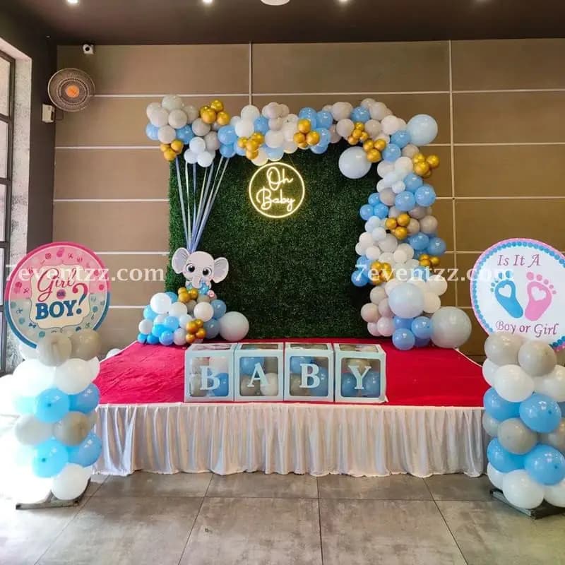 Godh Bharai baby shower stage setup with traditional floral and fabric decoration