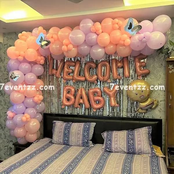 Baby homecoming decoration at home with welcome balloons, foil letters, and colorful backdrop