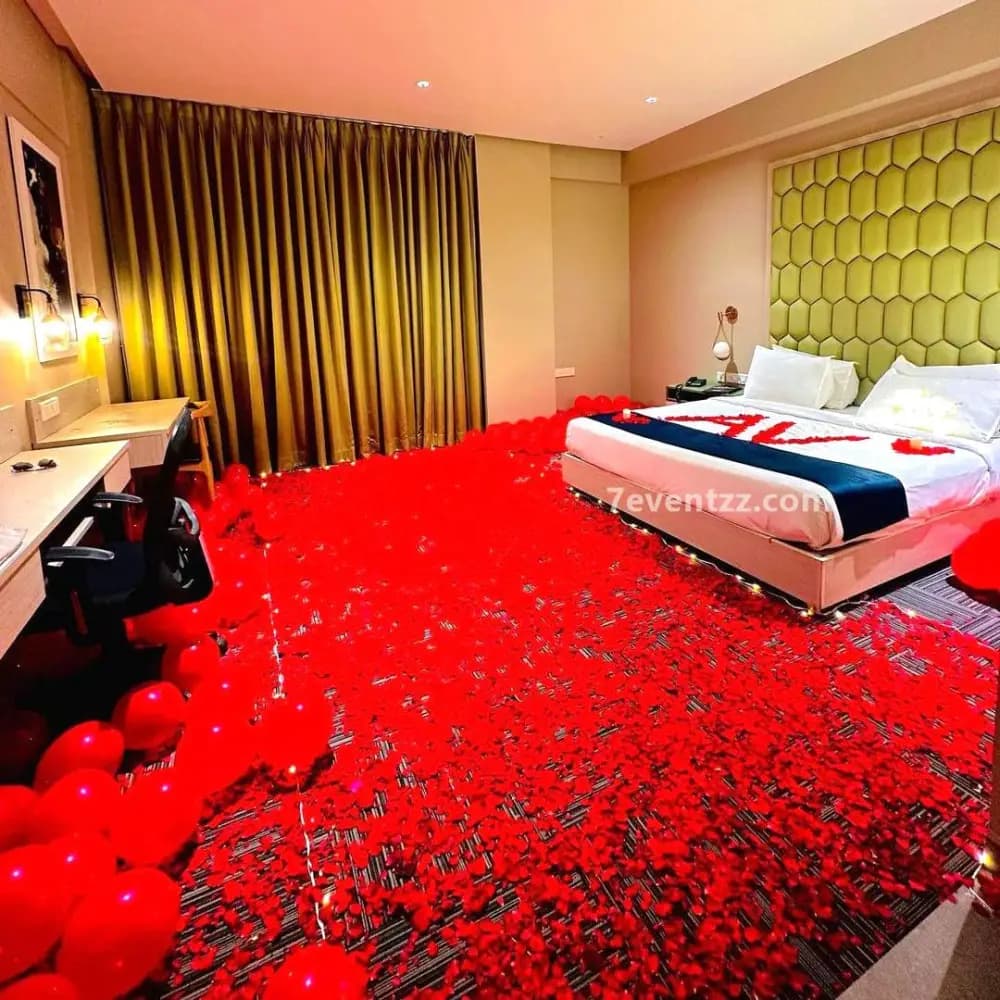 Floral wedding night room decoration with rose petals and candles