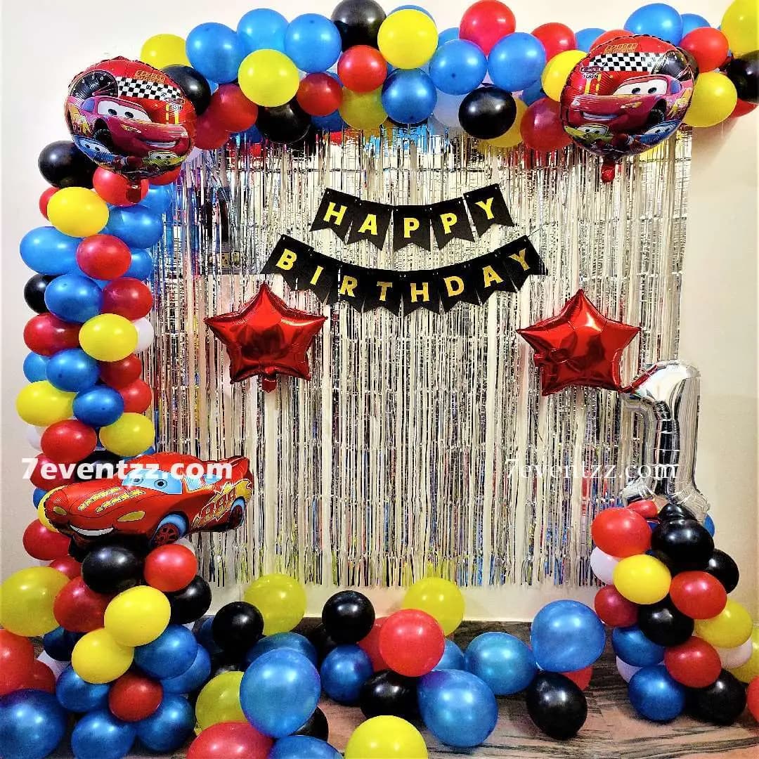 Cars theme birthday decoration with themed props and balloon arrangement