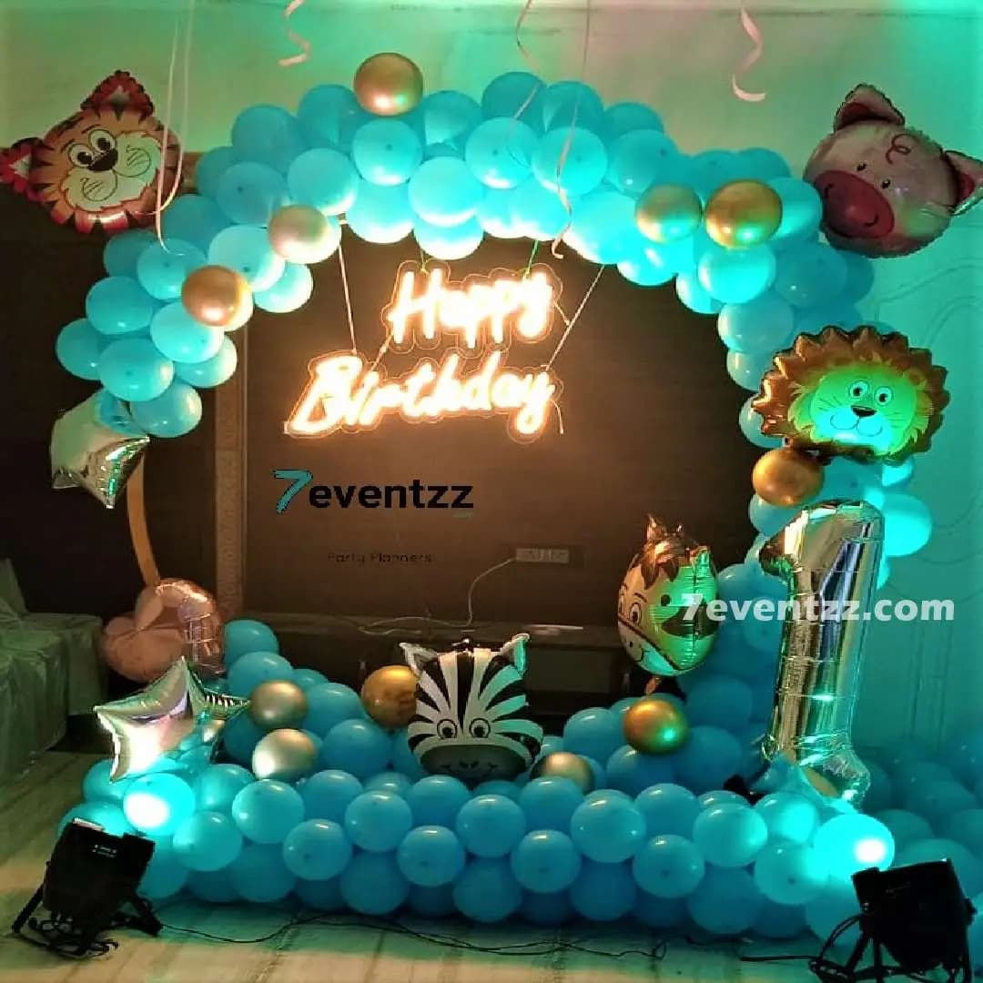 Animal theme birthday decoration with jungle animal cutouts and colorful balloon setup