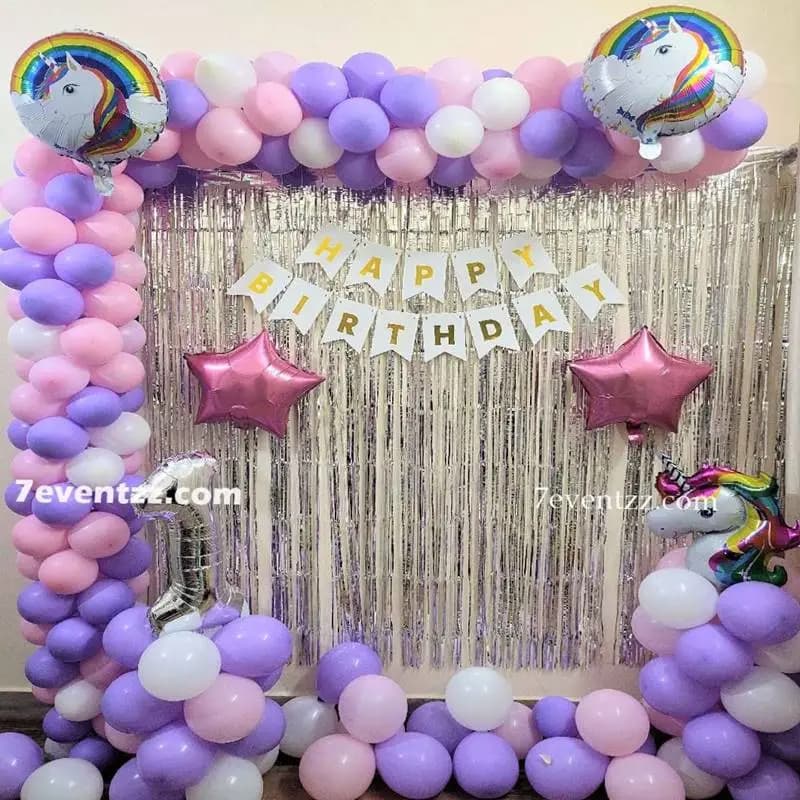 Unicorn theme birthday decoration setup with pastel balloons and unicorn character elements