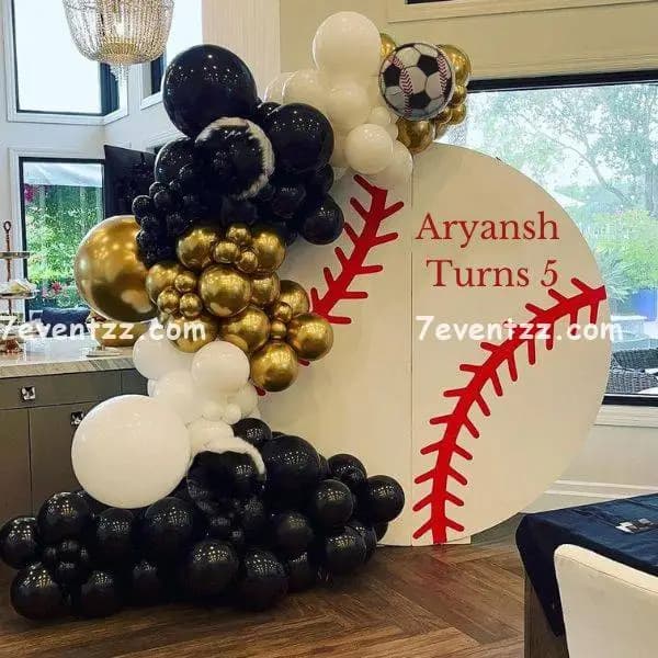 Football theme birthday decoration with sports-themed balloon arch and backdrop