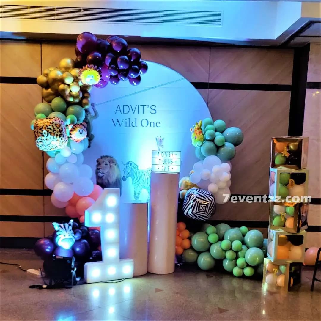 Animal theme stage decoration for kids birthday with jungle safari backdrop and props