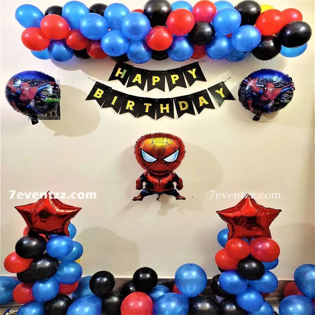 Spiderman themed birthday decoration with red and blue balloons and backdrop