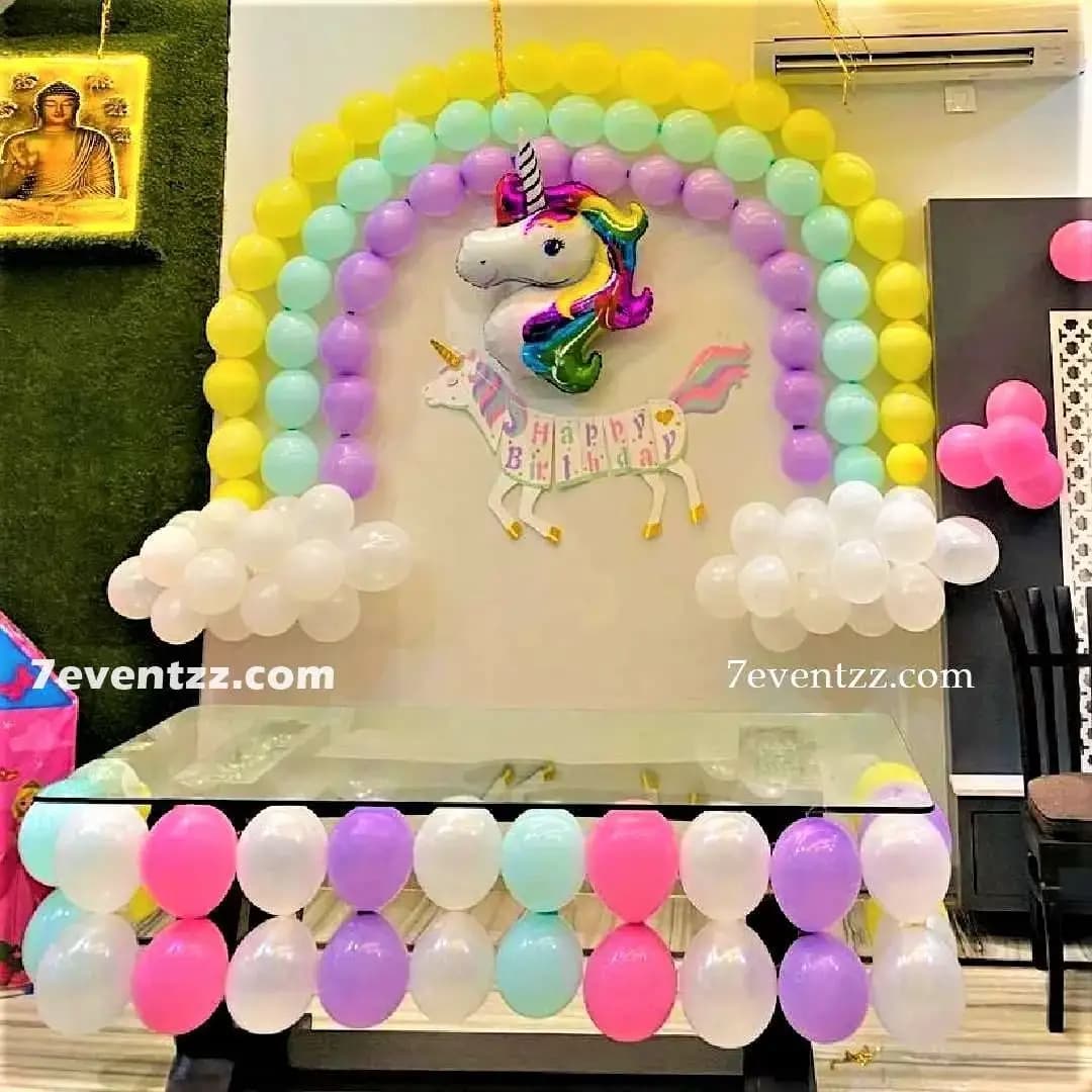 Unicorn themed hall decoration with rainbow and pink balloon garland