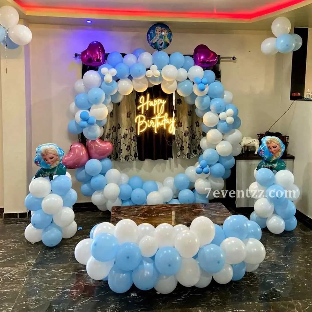 Frozen theme birthday party backdrop with Elsa design and matching blue balloon decor