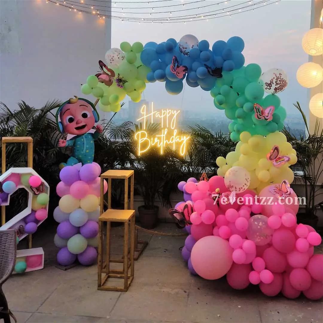 Cocomelon theme birthday decoration with green and red watermelon balloons and JJ character props for kids