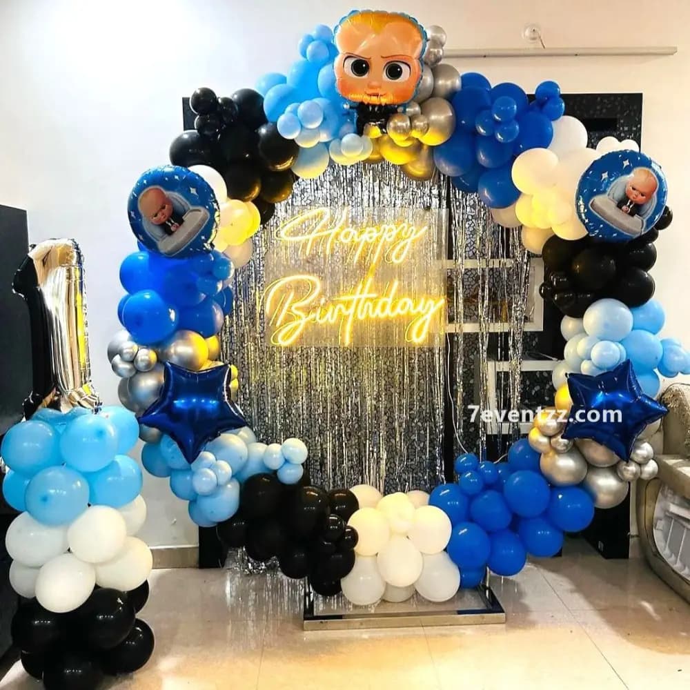 Boss Baby balloon ring decoration with themed arch and character props for kids birthday