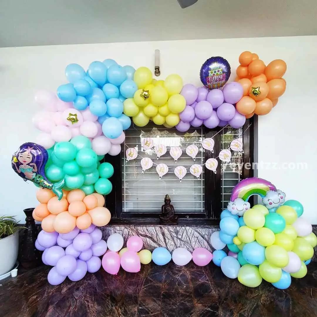 Soft pastel themed birthday decoration with balloon arrangement for kids