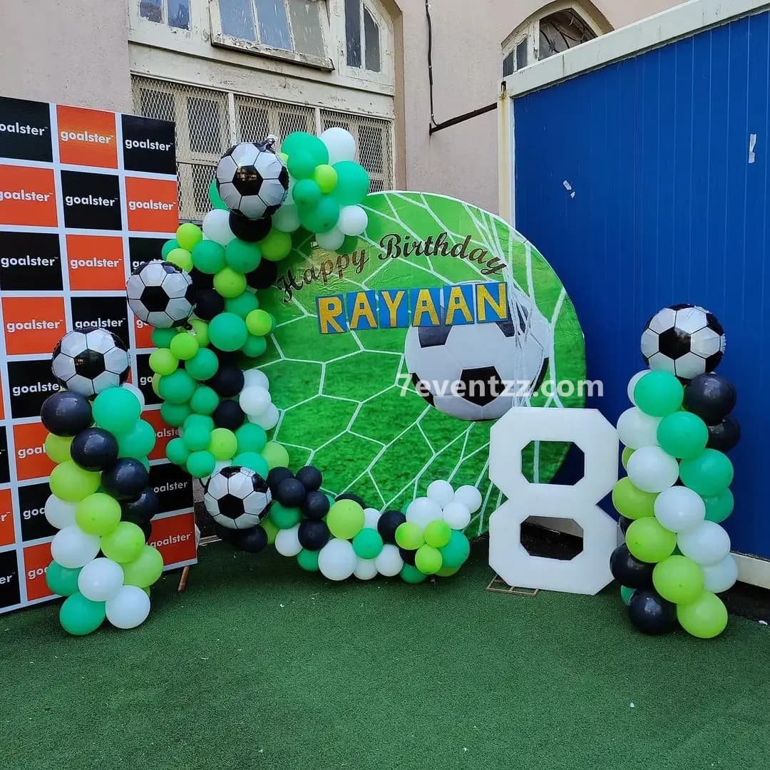 Premium football theme birthday decoration setup with large backdrop and balloon arrangements