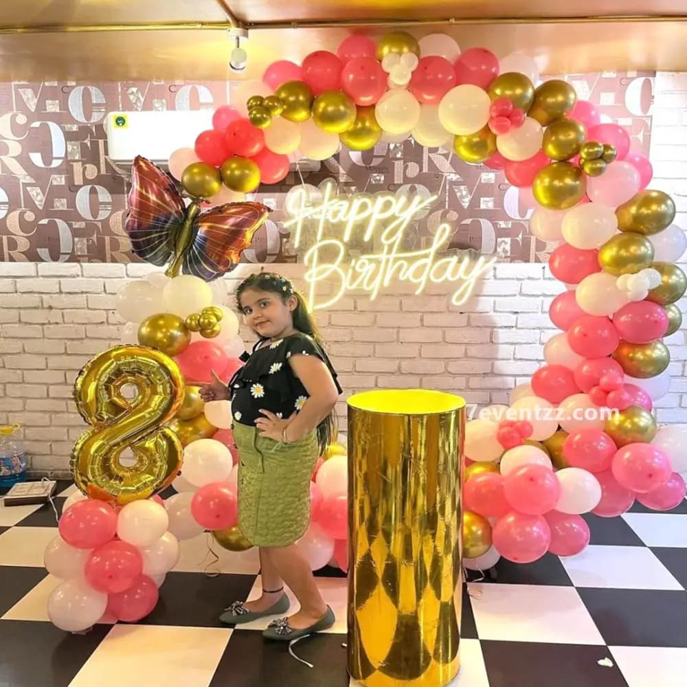 Butterfly themed ring balloon setup with floral and butterfly accents for birthday party