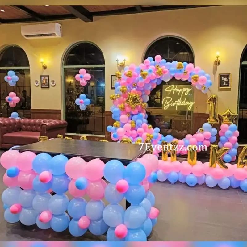 Pink and blue themed birthday stage decoration with matching balloon arrangement