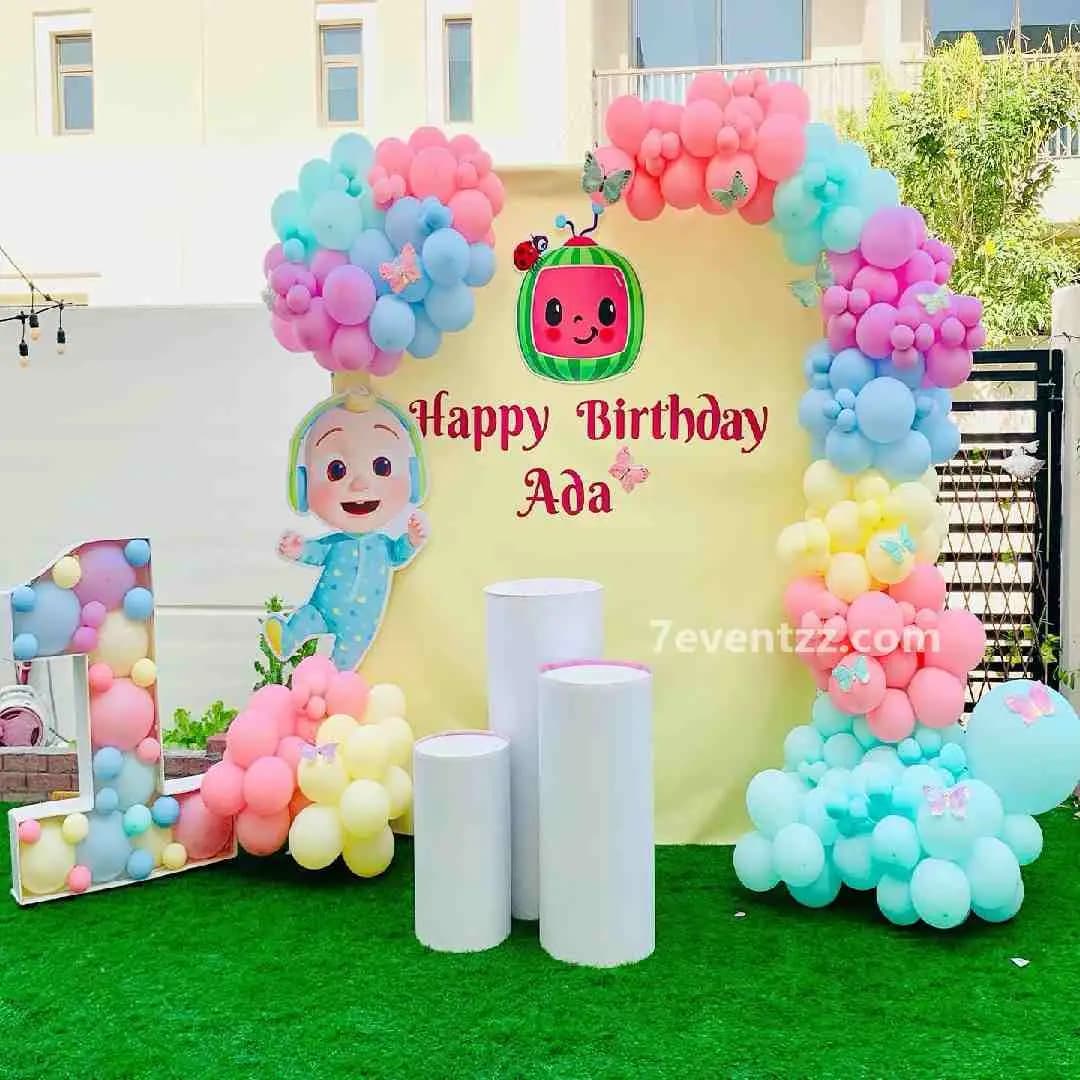 Outdoor Cocomelon themed birthday party decoration with balloon setup