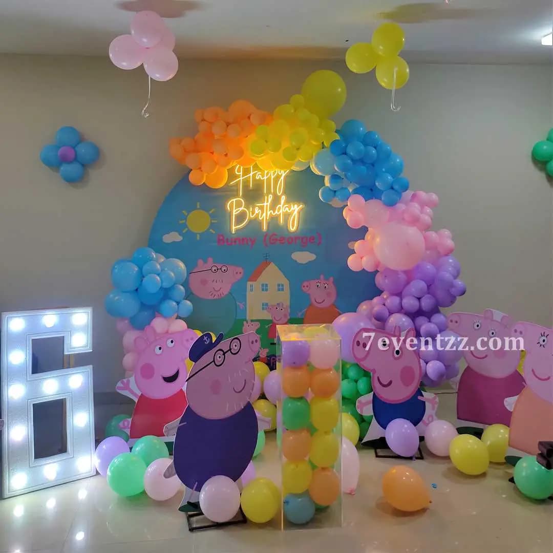 Peppa Pig themed birthday stage decoration with character backdrop and balloons