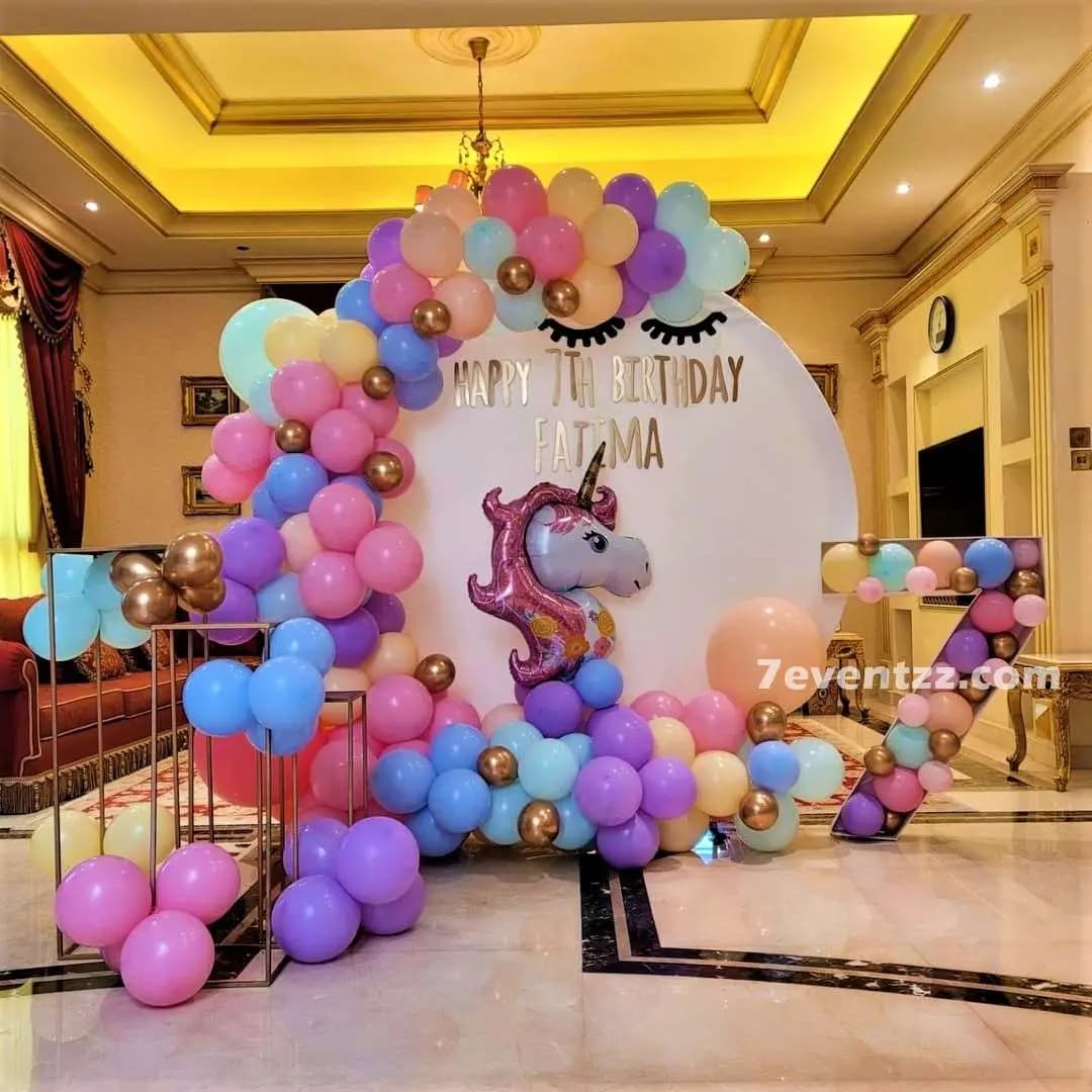 Grand unicorn theme stage decoration with large pastel balloon arch and unicorn character display