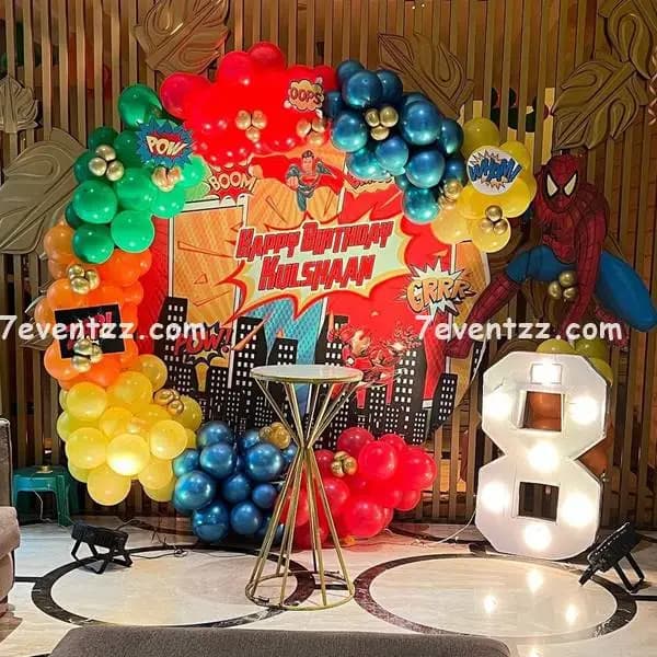 Superhero theme stage decoration with colorful balloon arrangement and printed backdrop for kids birthday by 7eventzz
