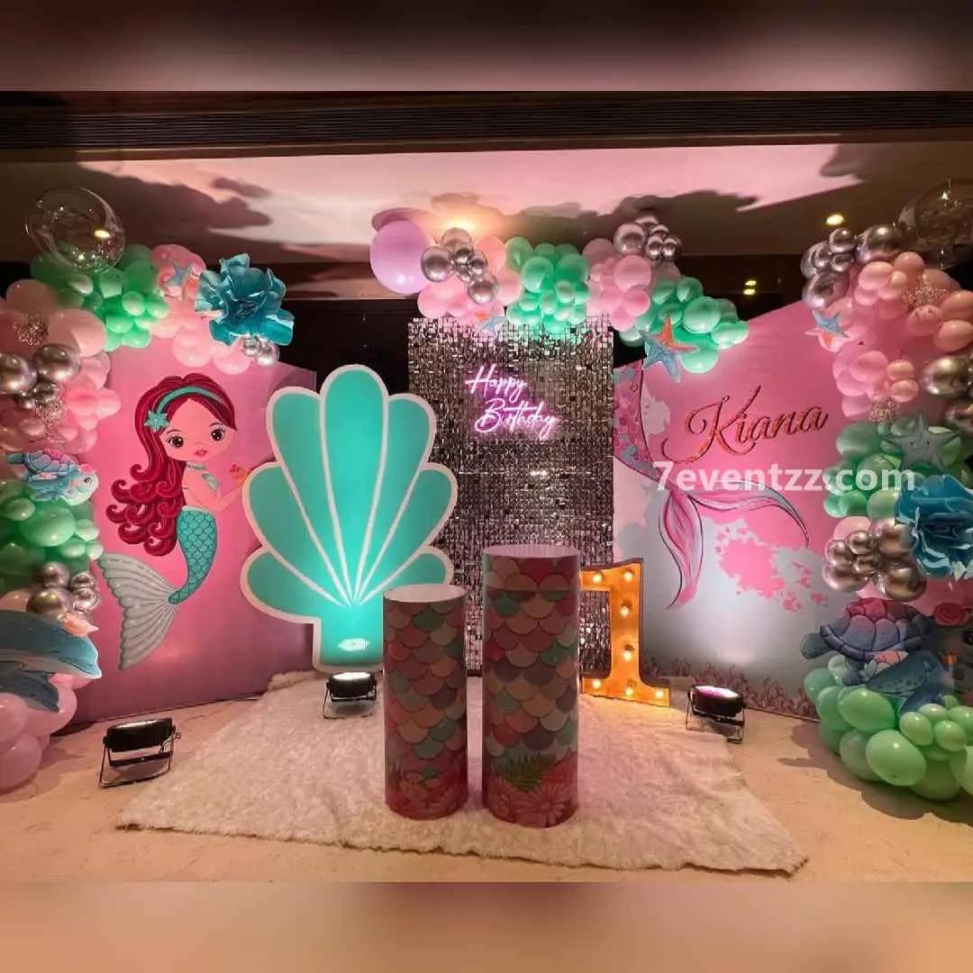 Mermaid theme stage decoration with large balloon arrangement, underwater backdrop, and sea elements for kids birthday by 7eventzz