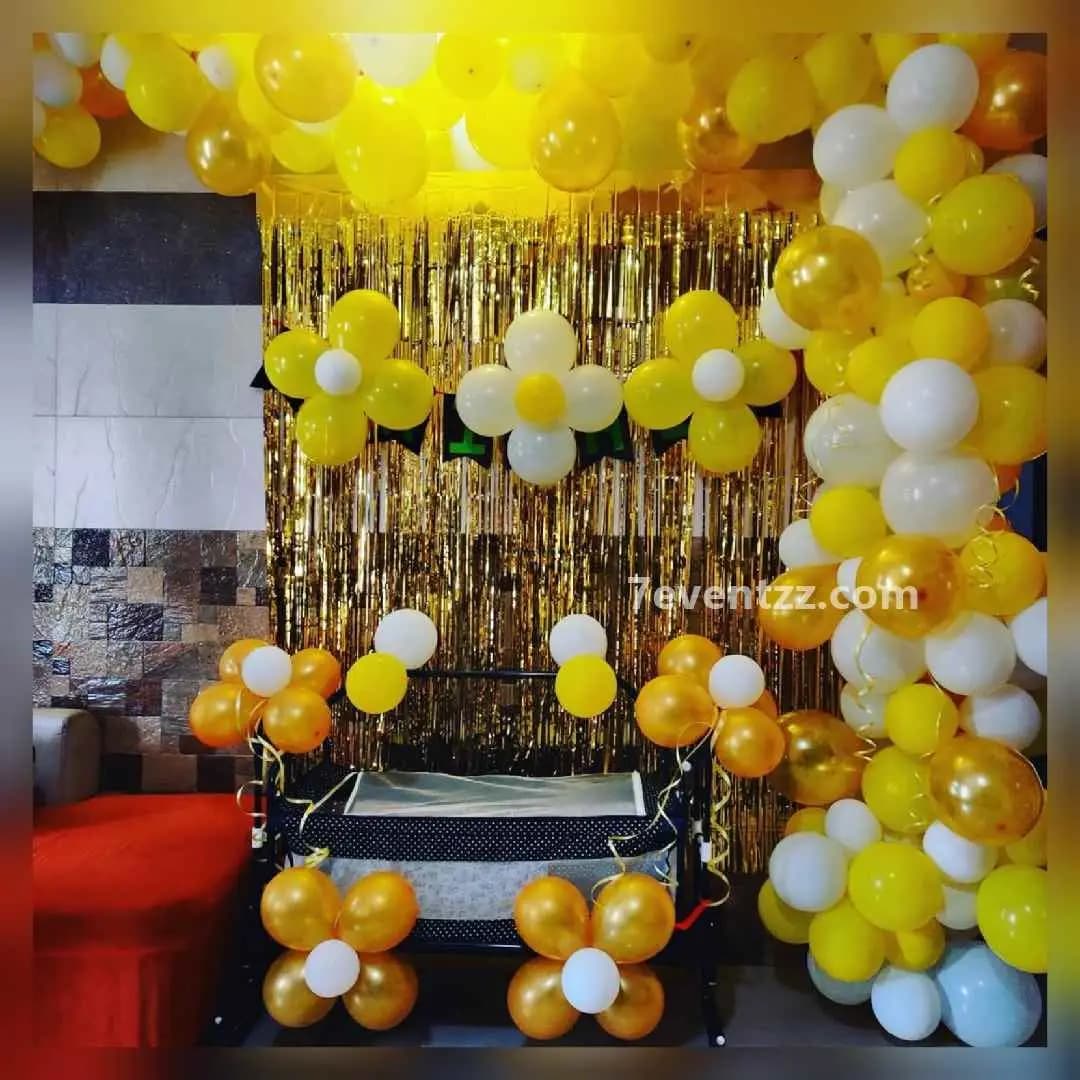 Wall-mounted arch decoration for naming ceremony with balloon styling