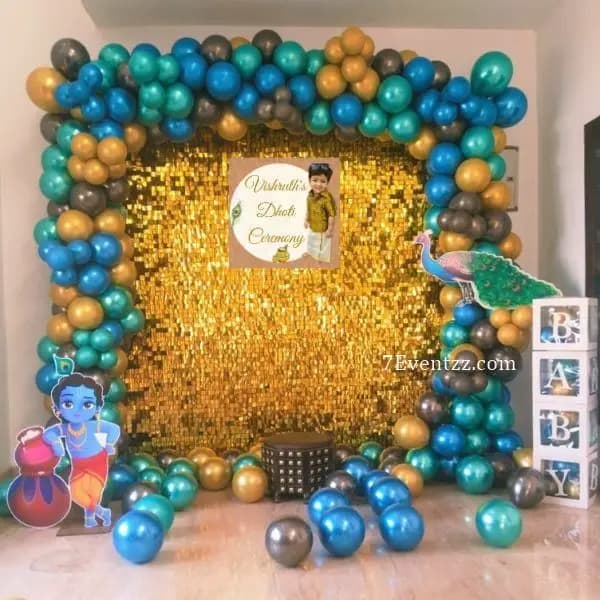 Dhoti ceremony decoration with sequin backdrop and traditional festive props