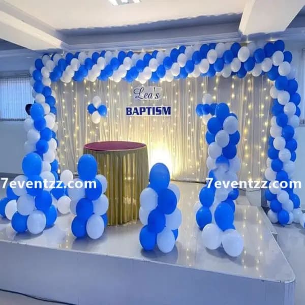 Full stage backdrop setup for baptism ceremony with decorative balloons