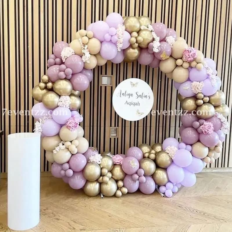 Aqiqah ceremony decoration with themed backdrop and balloon arrangements