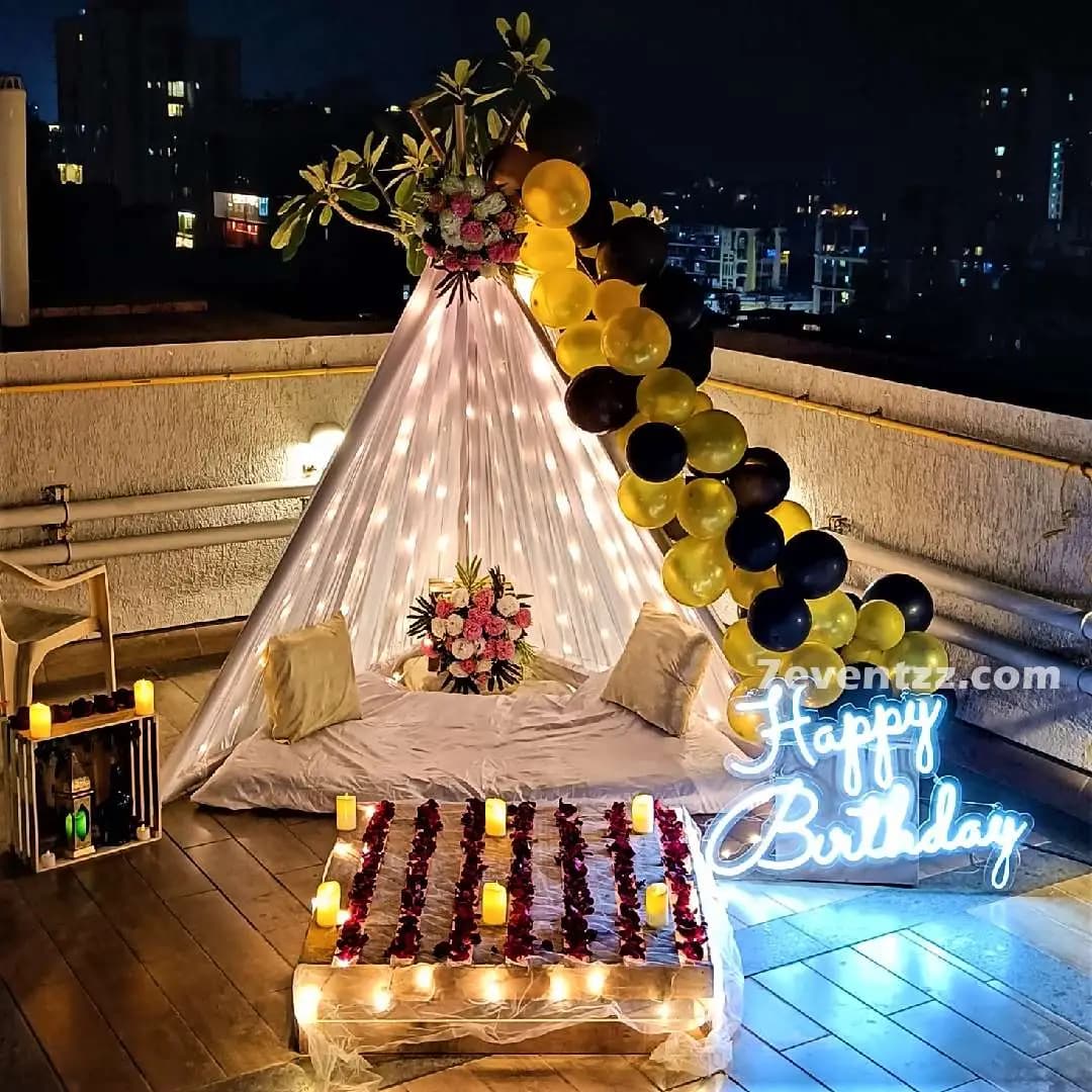 Birthday terrace canopy decoration with draped fabric and festive balloons