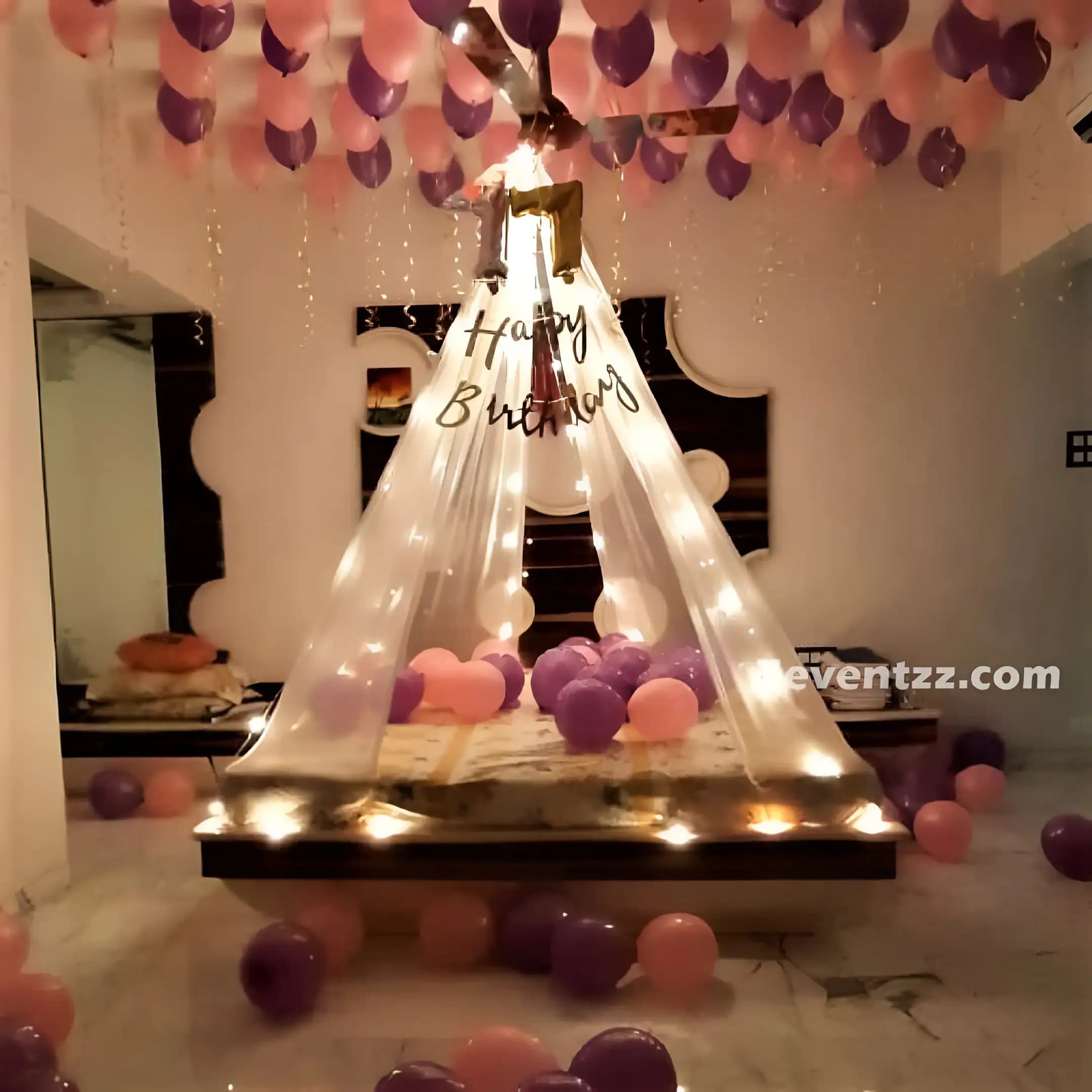 Bed canopy birthday decoration with balloon arrangement and decorative draping