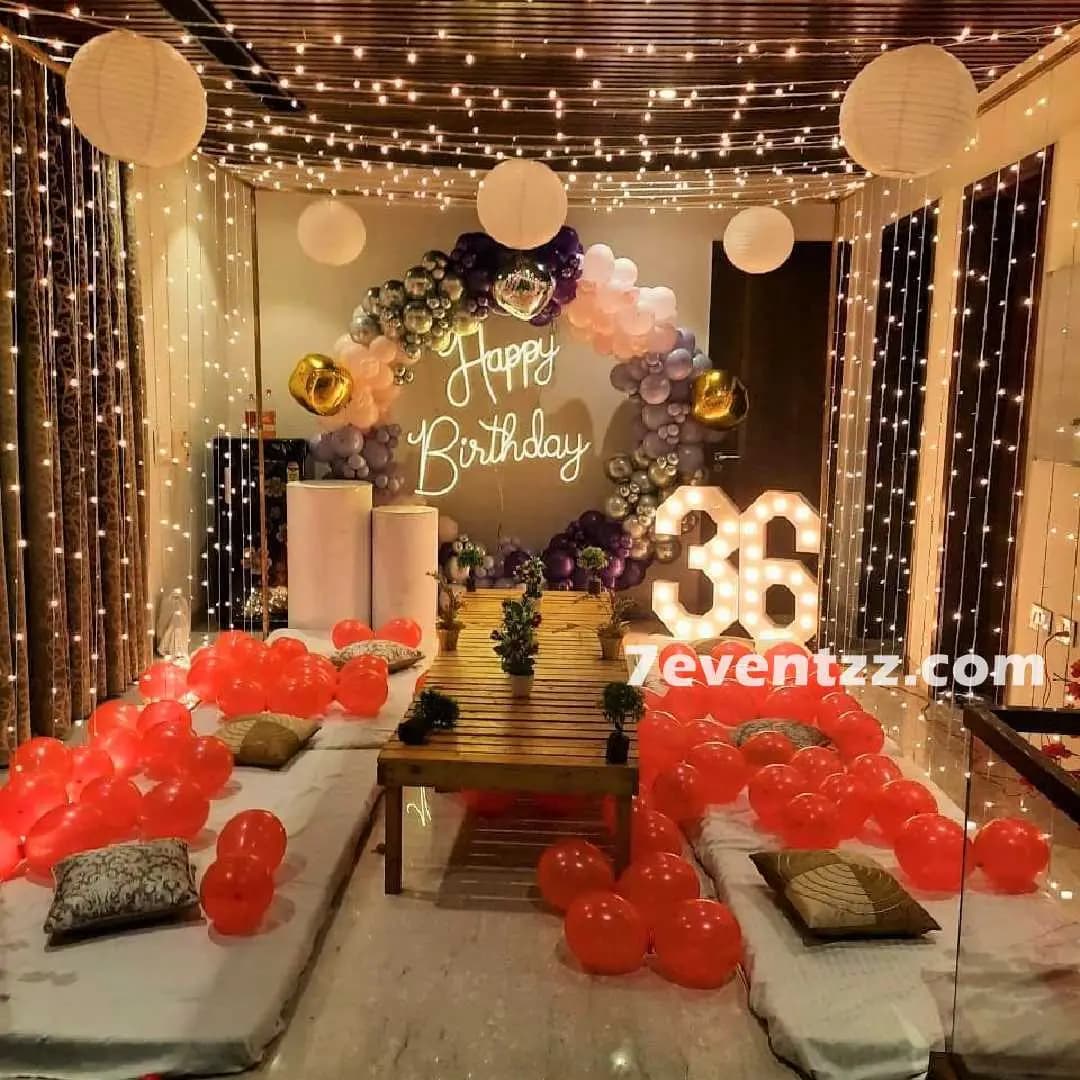 Grand birthday terrace decoration with balloon arch, personalized name backdrop, and string light canopy – 7eventzz