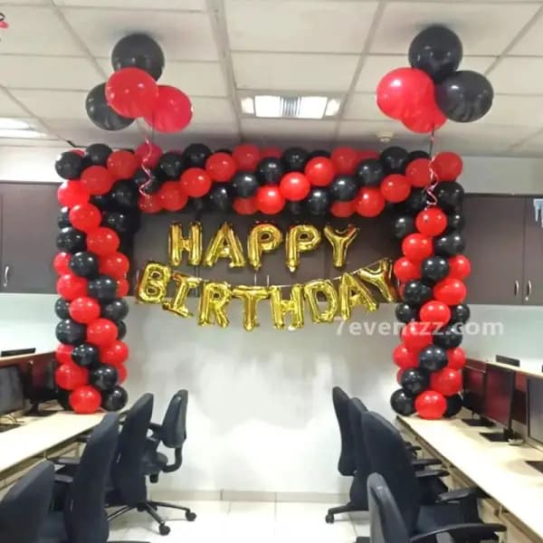 Birthday decoration in office space with colourful balloons and themed backdrop