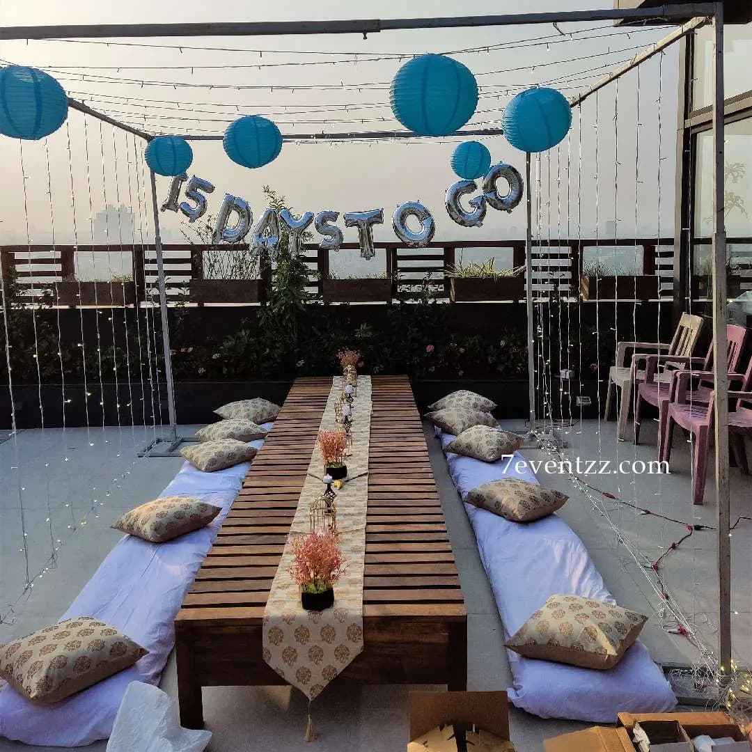 Terrace bachelorette party decoration with fairy lights and balloons