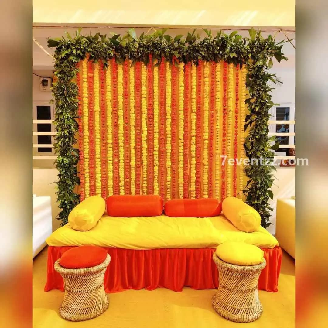 Elegant haldi ceremony setup with marigold and drapes