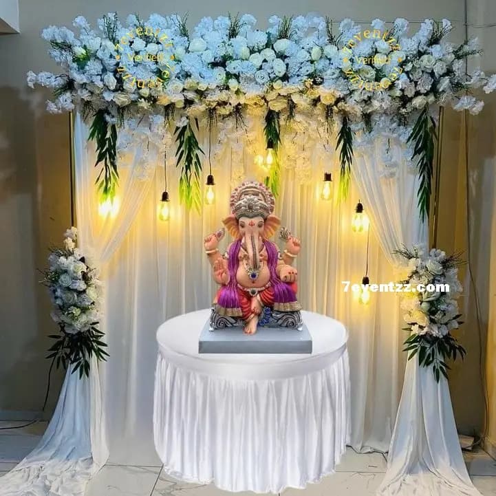 Beautifuk white floral decoration setup for Ganpati idol