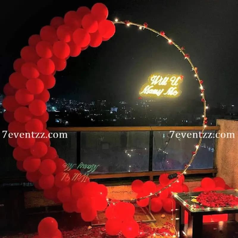 Will you marry me decoration setup with letter balloons and floral arrangement