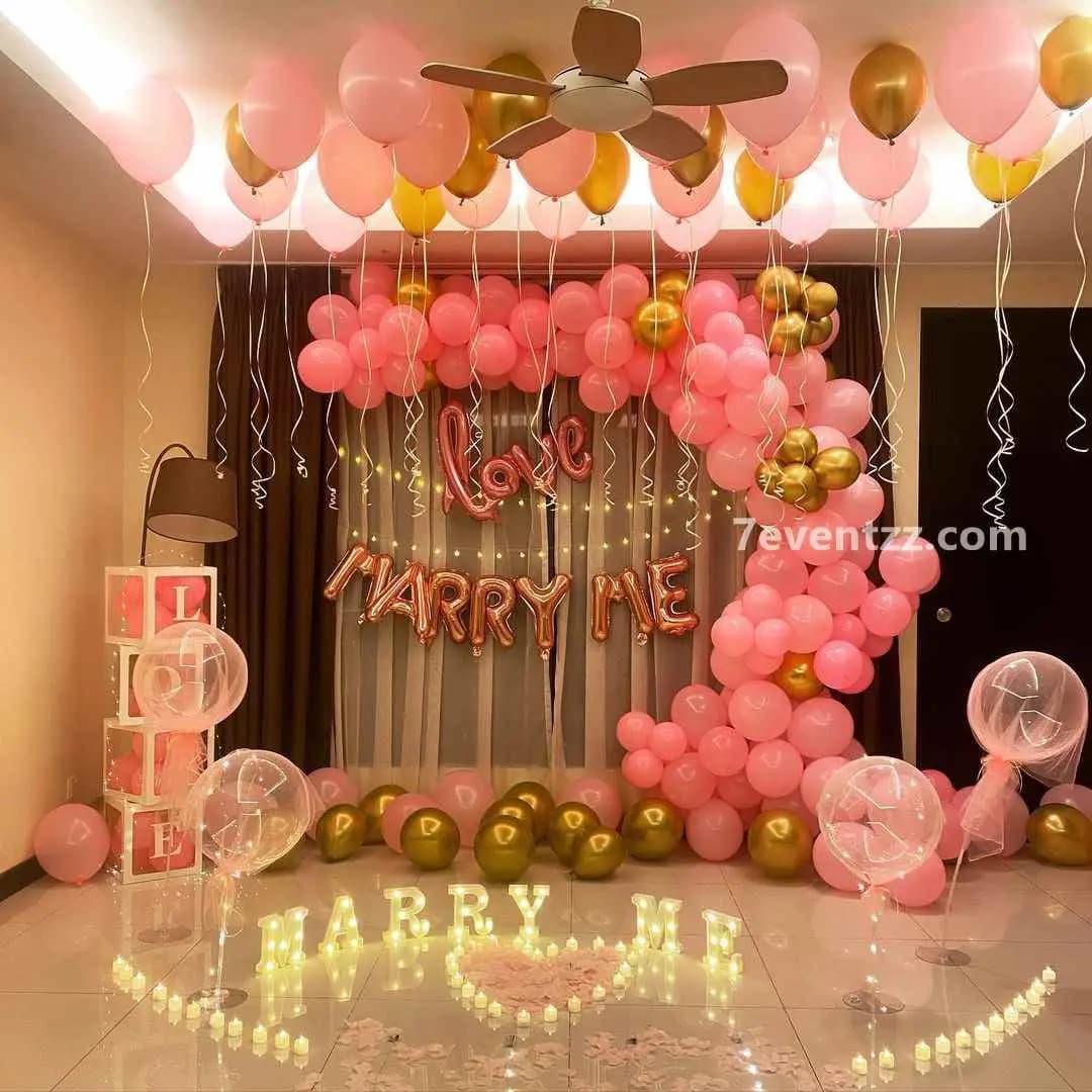 Marry me balloon decoration with red and white balloons spelling a proposal message