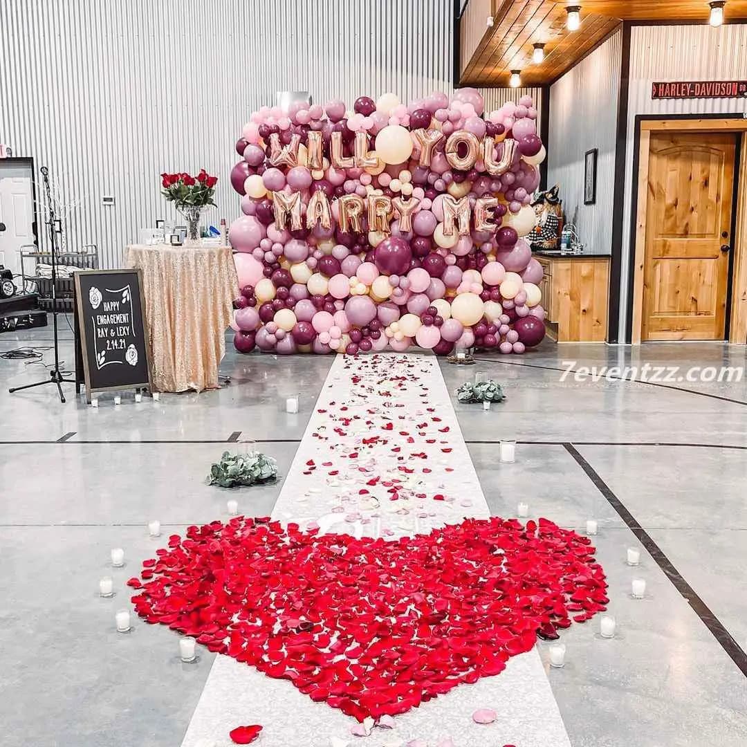 Decorative proposal balloon wall with mixed balloons and romantic backdrop