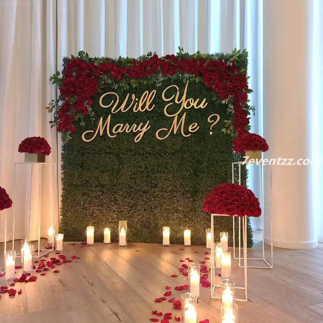 Marry me backdrop setup with large balloon arch and flower arrangement