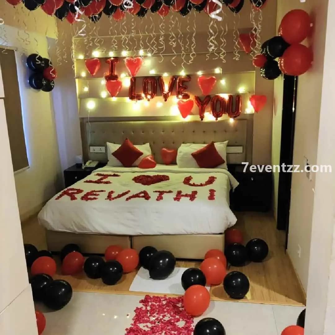 Valentine-themed room decoration with red roses, heart balloons, and candles