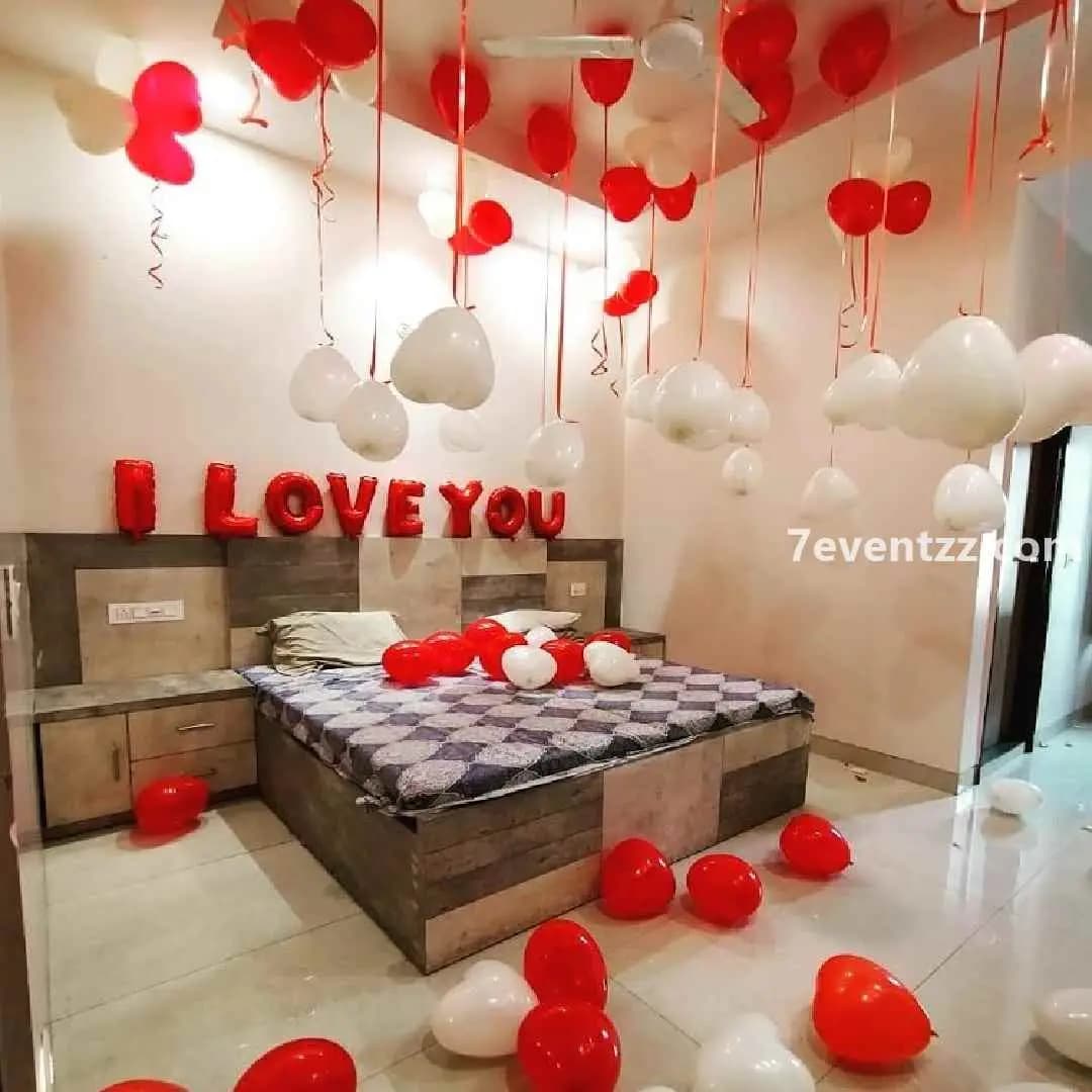 Simple proposal room decoration with rose petals and minimal balloon setup