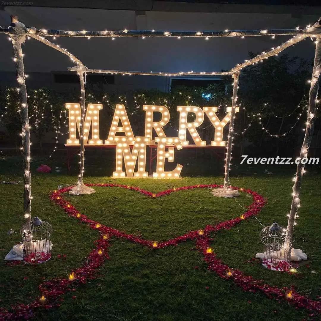 Outdoor marry me decoration setup with large floral and balloon display