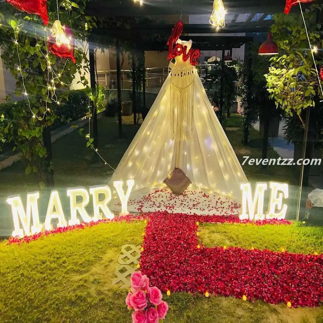 Private proposal canopy decoration with drapes, flowers, and soft lighting