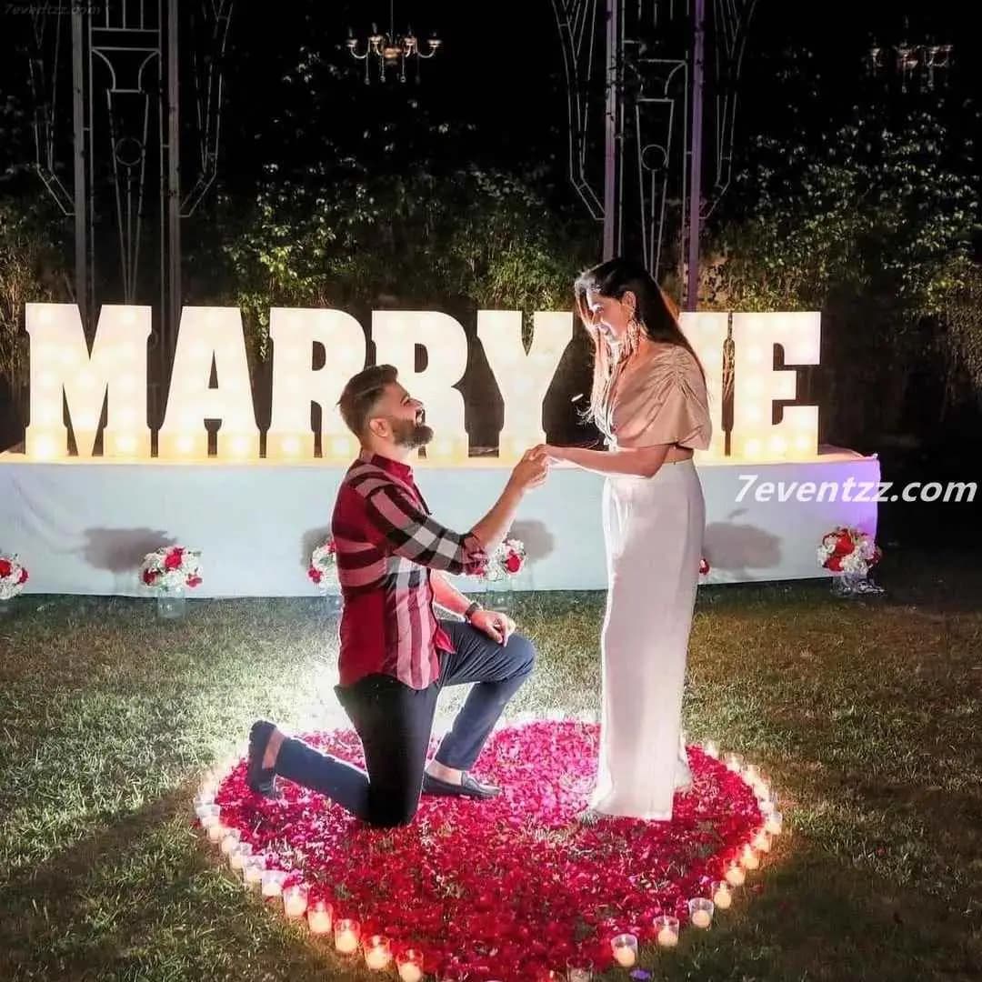 Marry me surprise decoration with personalized balloon setup and floral accents