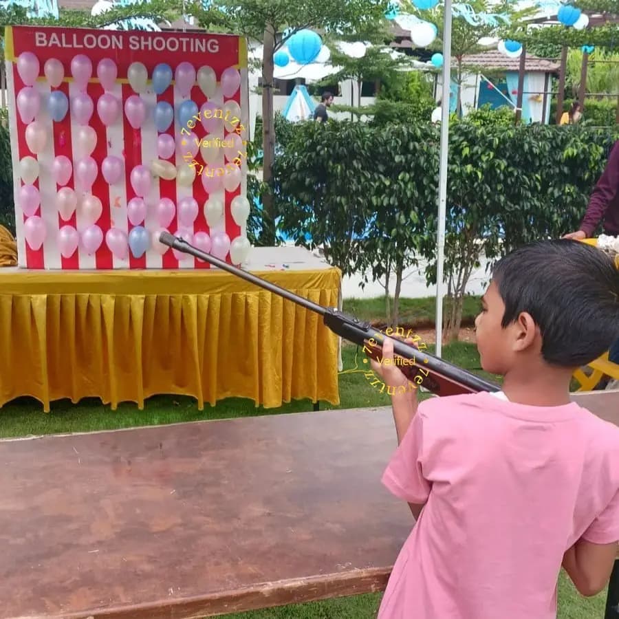 Balloon shooting game activity at a children's birthday party